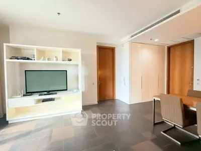 Spacious modern living room with sleek furniture and large TV unit, perfect for relaxation and entertainment.