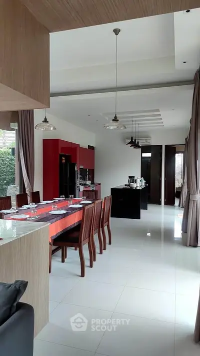 Spacious modern kitchen and dining area with sleek design and ample natural light.