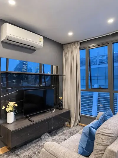 Modern living room with city view, sleek furniture, and air conditioning for ultimate comfort.