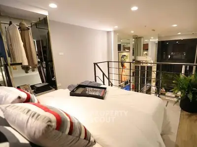 Modern loft bedroom with stylish decor and open closet space