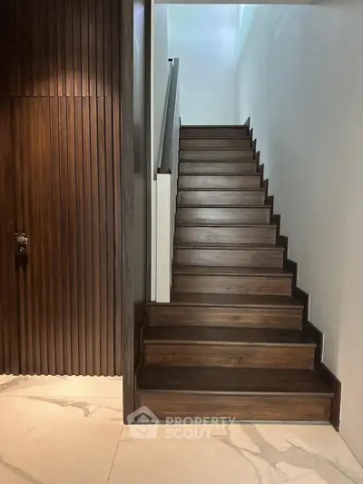 Elegant wooden staircase with modern design and sleek finishes in a contemporary home interior.