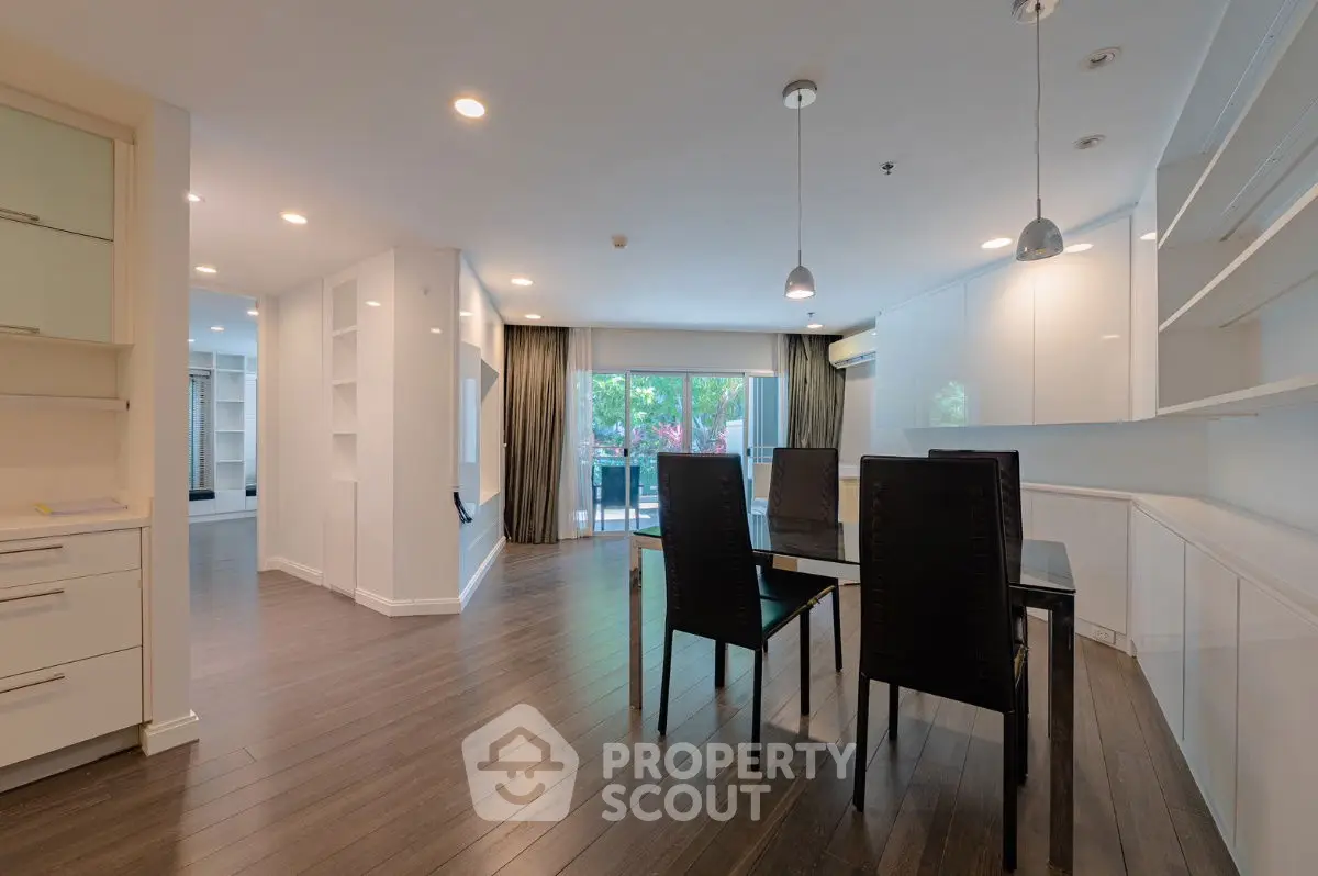 Spacious dining area with modern design and large windows opening to a balcony.