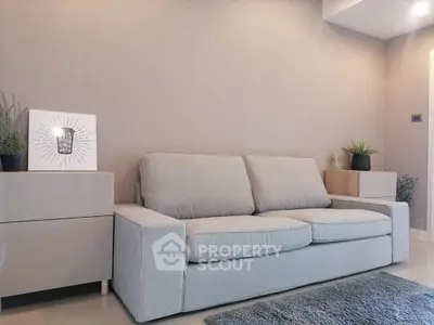 Modern living room with stylish gray sofa and minimalist decor