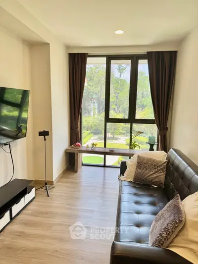 Stylish living room with large window and garden view, featuring modern decor and cozy seating.