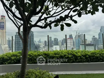 Stunning cityscape view from rooftop garden with lush greenery and skyline backdrop.