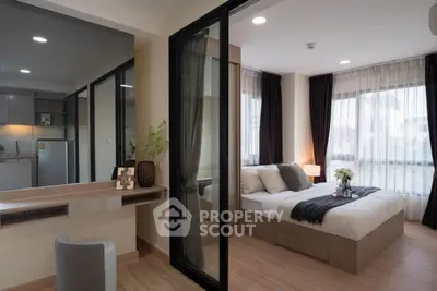 Modern bedroom with large windows and stylish decor in a contemporary apartment.