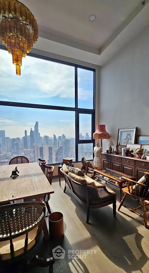 Stunning living room with panoramic city view, elegant decor, and abundant natural light.