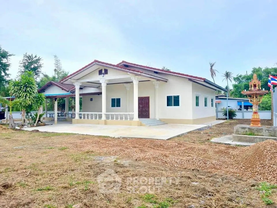 Charming single-story house with spacious front yard and traditional architectural elements.