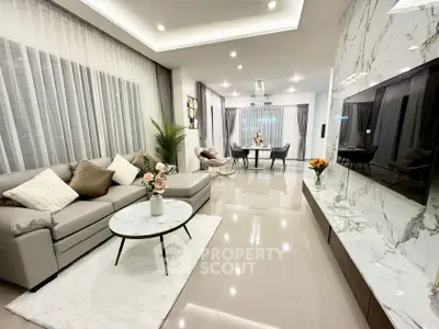 Luxurious modern living room with elegant marble accents and spacious open layout.
