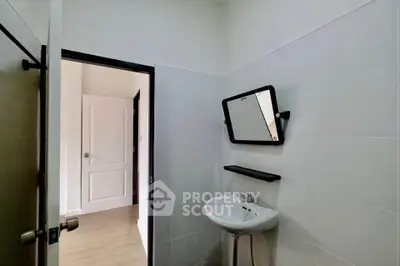 Minimalist bathroom with white tiles and modern sink