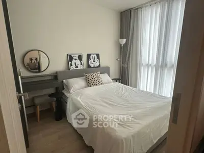 Cozy bedroom with modern decor and large window for natural light