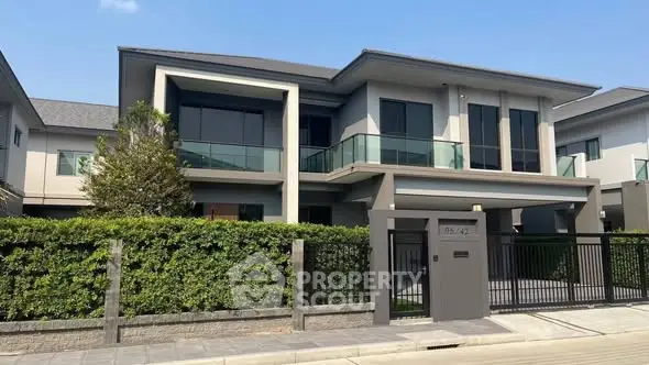 Modern two-story house with sleek design and spacious balcony in a serene neighborhood.