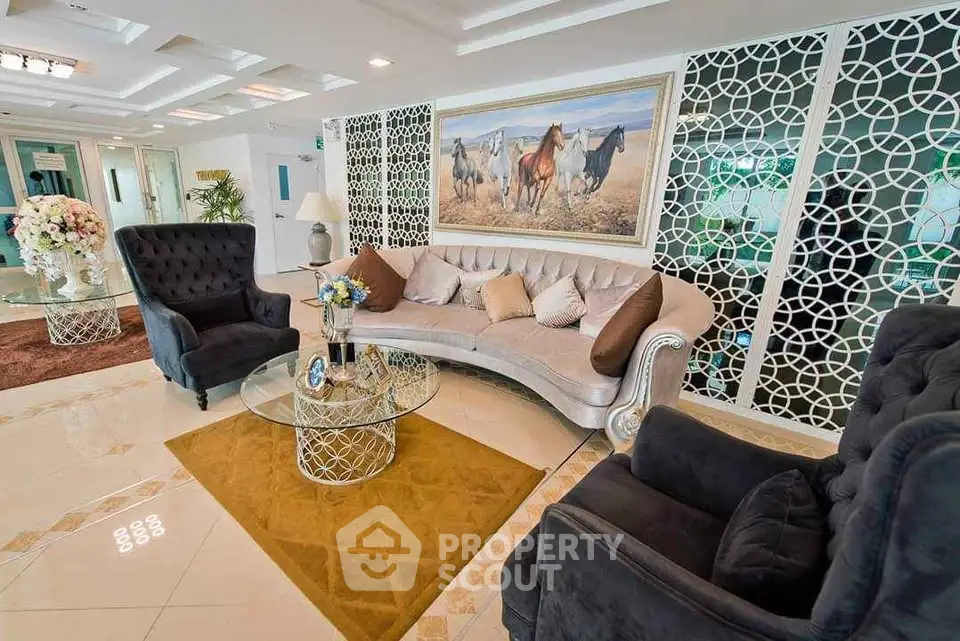 Luxurious living room with elegant furniture and stylish decor, featuring a plush sofa and armchairs.