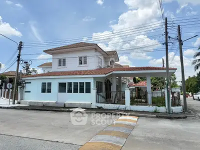 Charming two-story house with tiled roof and spacious front yard in a serene neighborhood.
