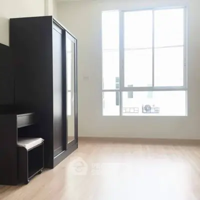 Bright bedroom with large window and modern furniture