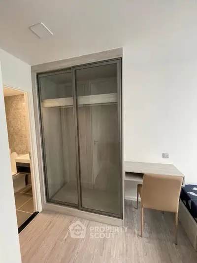 Modern bedroom with sleek wardrobe and study desk, perfect for urban living.