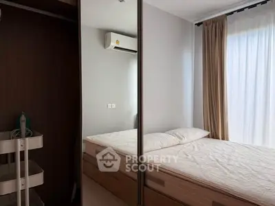 Modern bedroom with mirrored wardrobe and natural light