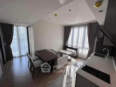 Modern living room with open kitchen, elegant curtains, and stylish furniture in a contemporary apartment.