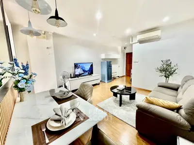 Modern living room with elegant decor, open layout, and stylish furniture in a cozy apartment.