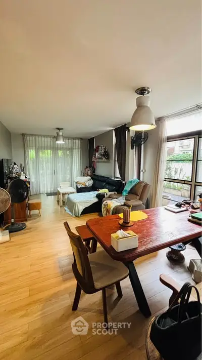 Spacious living room with modern decor and large windows offering natural light.