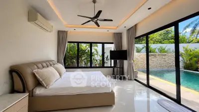 Luxurious bedroom with pool view and modern decor in tropical villa