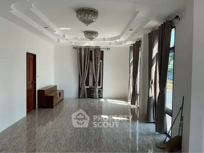 Spacious living room with elegant ceiling design and large windows