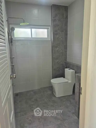 Modern bathroom with sleek tiles and contemporary fixtures.