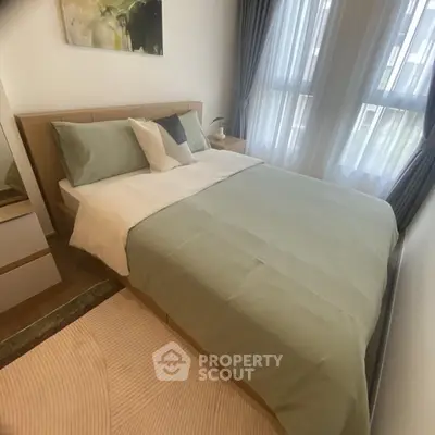 Cozy bedroom with modern decor and natural light from large windows.