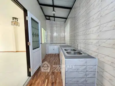 Modern kitchen with dual sinks and stylish tile backsplash