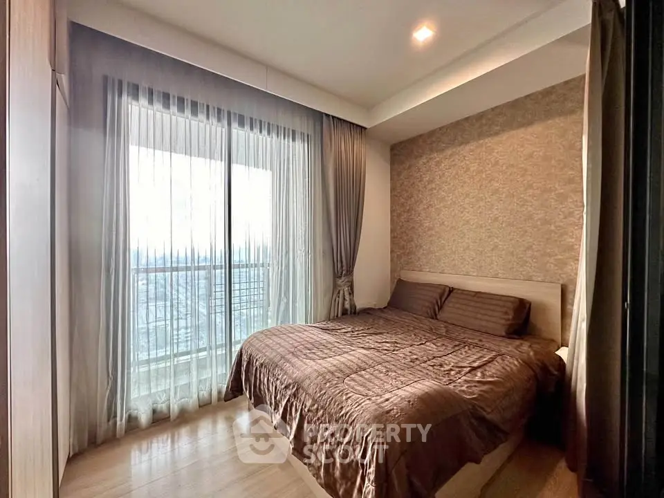 Cozy bedroom with elegant decor and large window for natural light