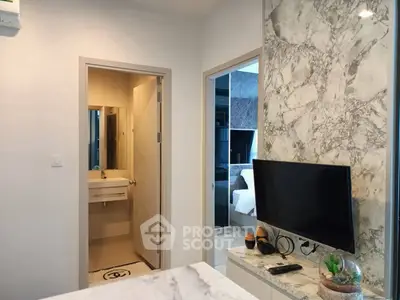 Modern apartment interior with marble accents and sleek TV setup