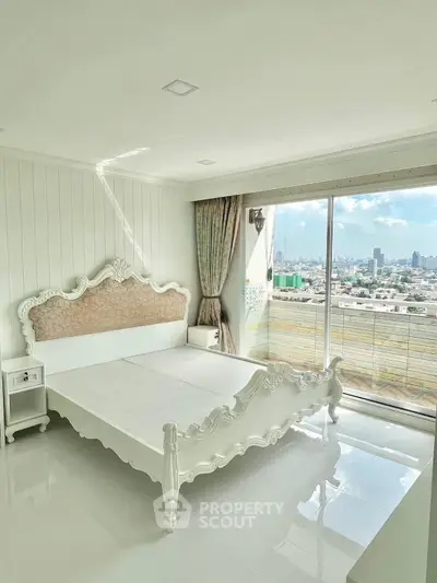Elegant bedroom with ornate bed and city view from large window