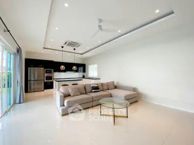 Spacious modern living room with open kitchen and sleek design