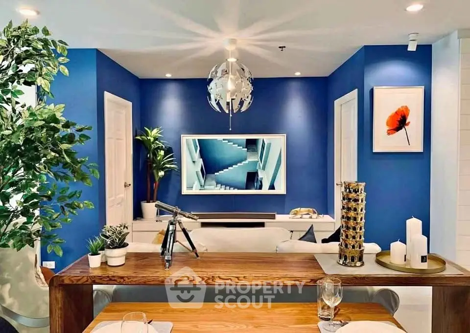 Stylish modern living room with blue accent wall and elegant decor