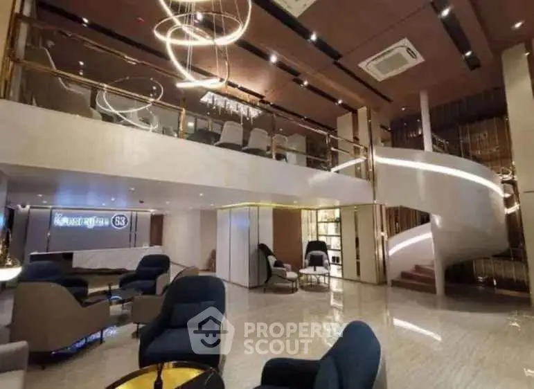 Luxurious modern lobby with elegant seating and spiral staircase