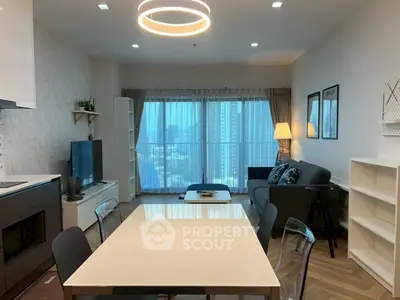 Modern living room with city view, stylish furniture, and elegant lighting in a high-rise apartment.