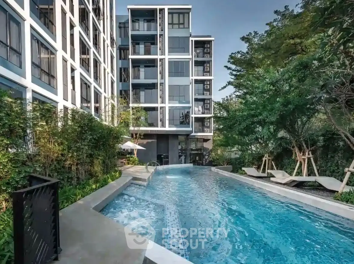 Modern apartment building with luxurious outdoor pool and lush greenery