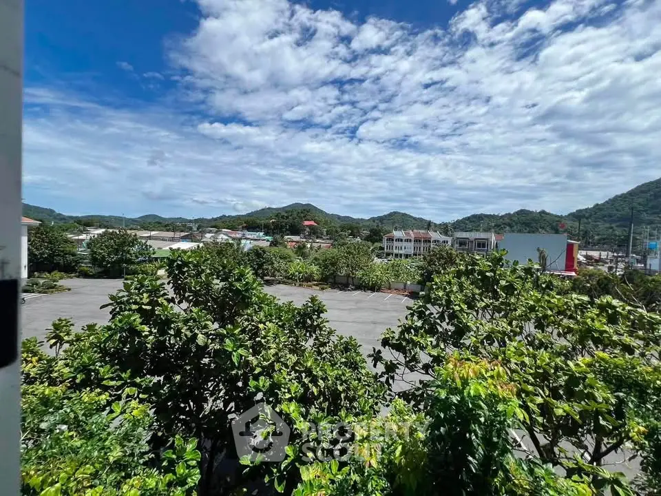Scenic view of lush greenery and distant hills from a real estate property, perfect for nature lovers.