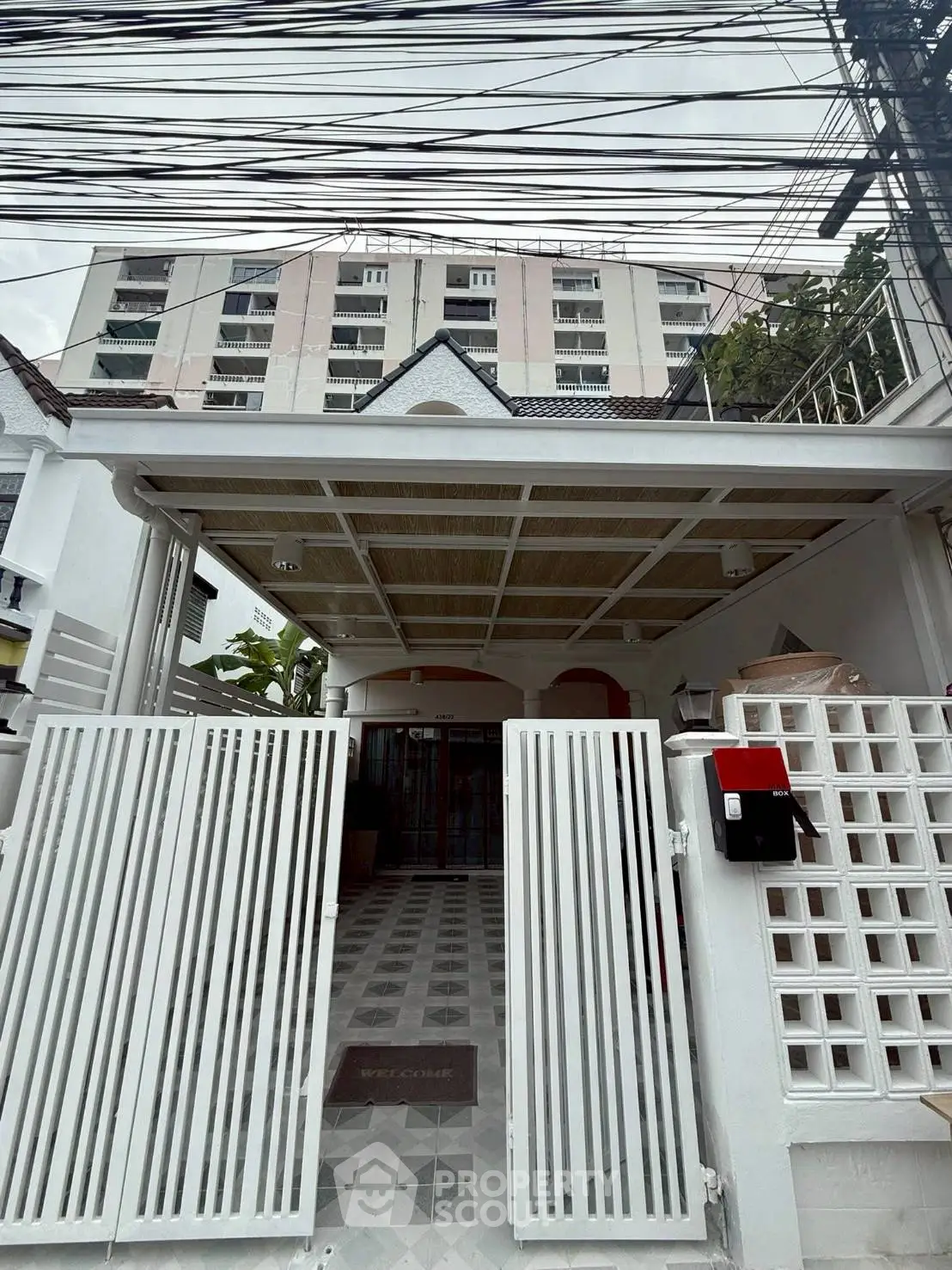Charming urban townhouse with gated entrance and modern facade, perfect for city living.