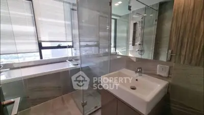Luxurious bathroom with glass shower and city view
