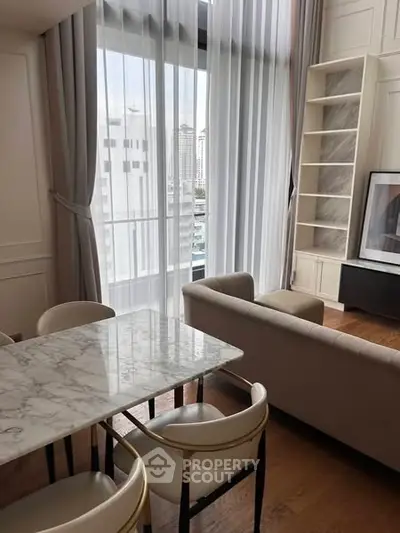 Elegant living room with marble dining table and city view through large windows.
