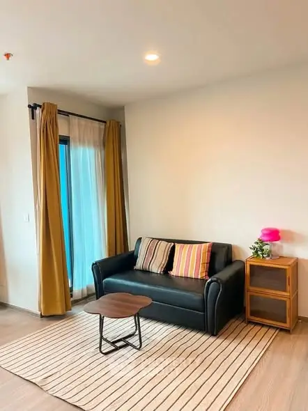 Cozy living room with modern sofa, stylish decor, and natural light