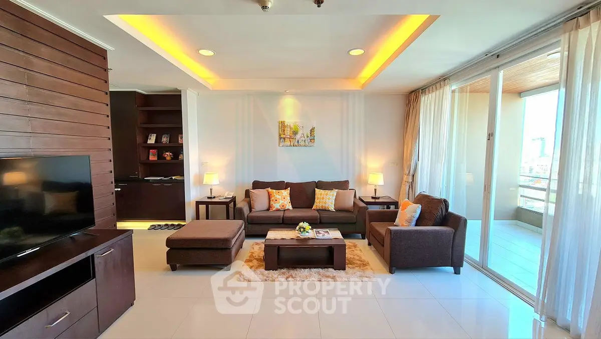 Spacious modern living room with elegant decor and large balcony access