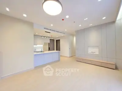 Spacious modern living room with open kitchen and sleek design