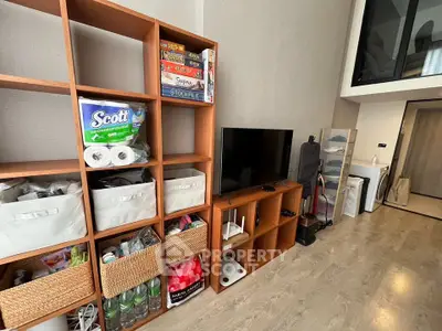 Modern living room with wooden shelving and entertainment setup