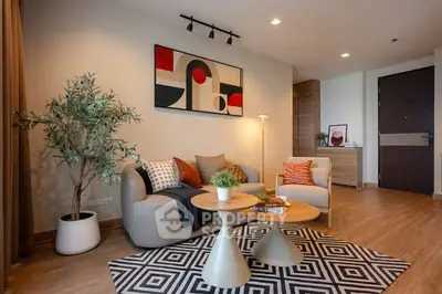 Stylish modern living room with abstract art and cozy seating area.