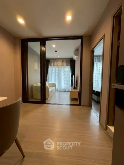 Modern apartment interior with open layout and large windows for natural light.