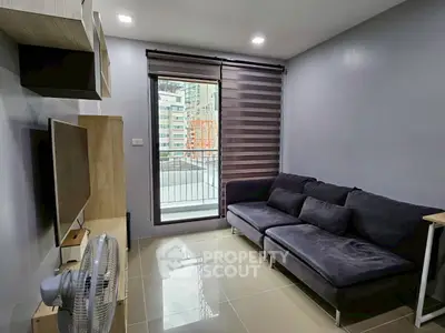 Modern living room with sleek sofa and balcony view in urban apartment