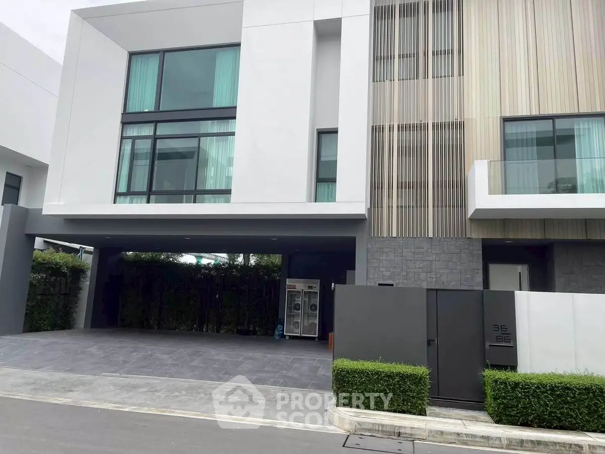 Modern townhouse exterior with sleek design and large windows in a serene neighborhood.