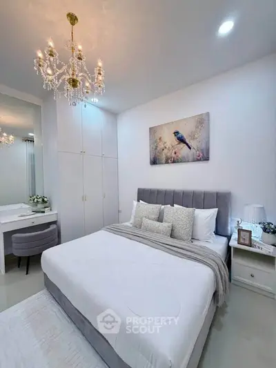 Elegant bedroom with chandelier and modern decor in a stylish apartment